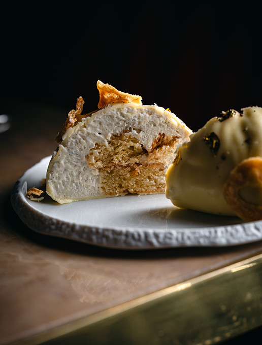 Dessert cut in half, revealing its rich texture, served at Dans le Noir ? restaurant