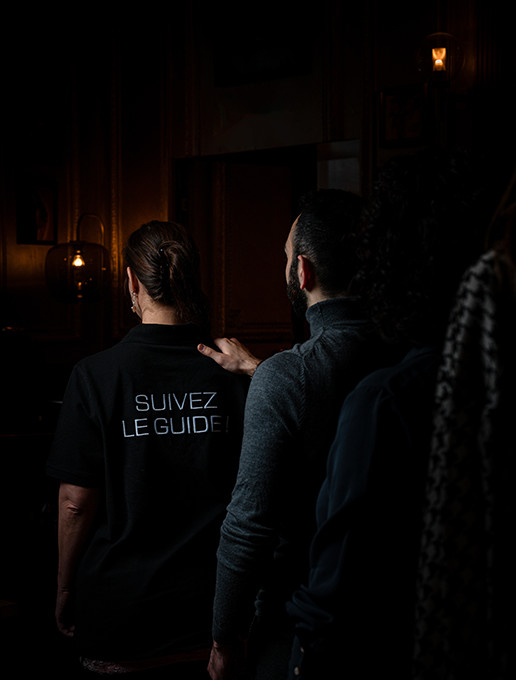 A group walking in single file, celebrating a bachelor party at Dans le Noir ? restaurant